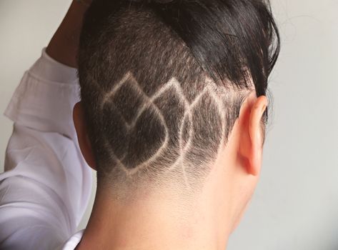Close-up of a geometric design shaved into the hair, showcasing modern hairstyling art.