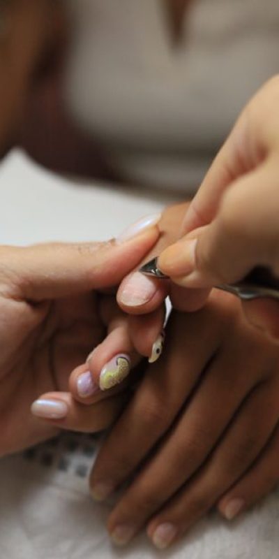 Close-up of a professional manicure process with cuticle trimming in Istanbul.